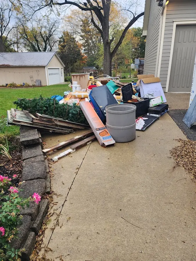 Dumpster being loaded with debris for Estate Cleanout Dumpster Rental in Cabot